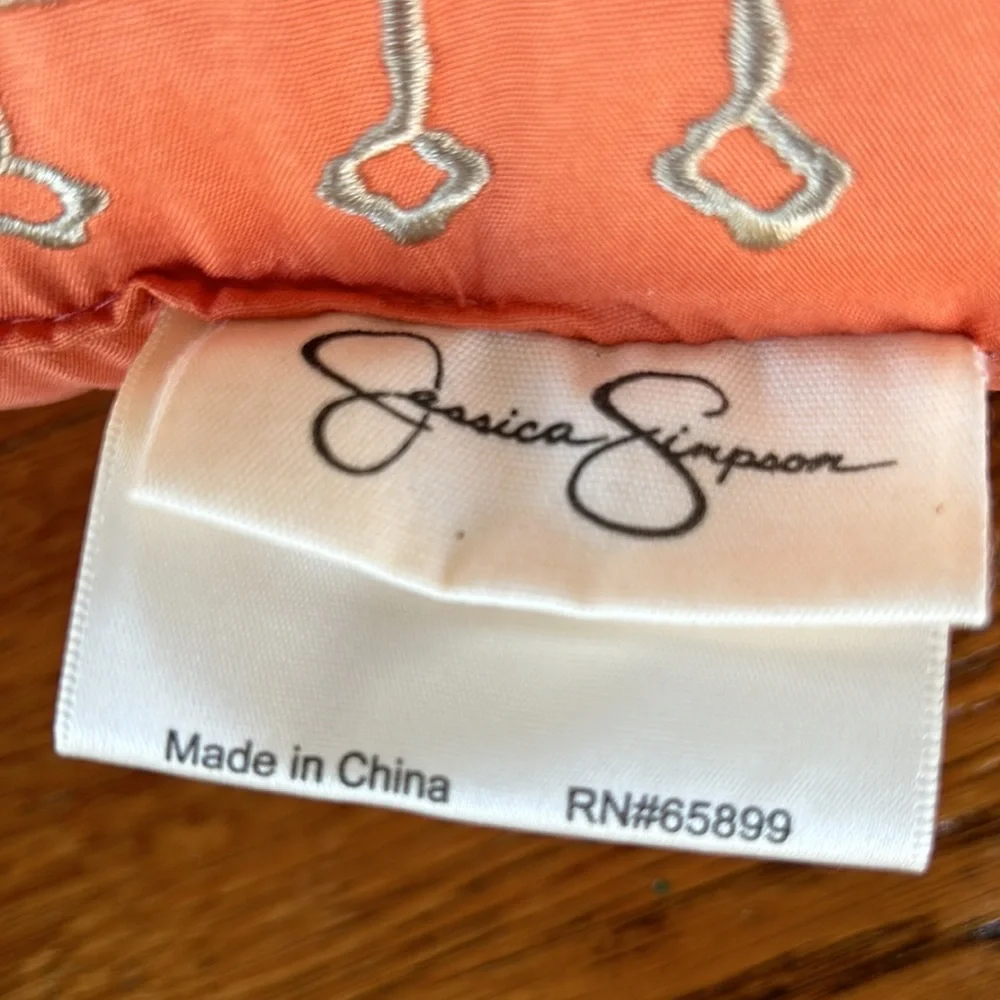 Jessica Simpson accent pillow.  Orange w/tan embroidery on one side.  12”x16.5”